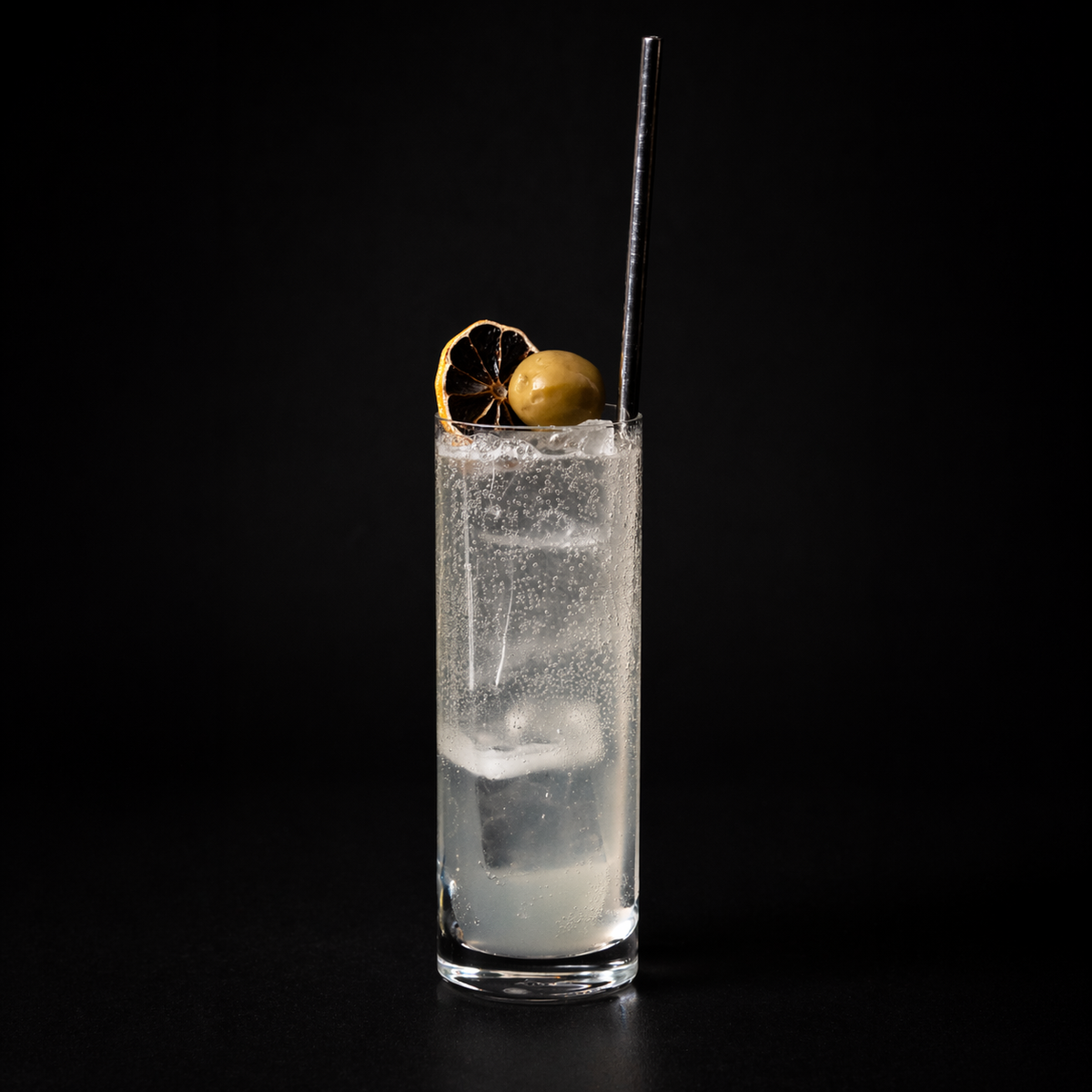 Empirical Olive highball cocktail with olive garnish and dried citrus wheel